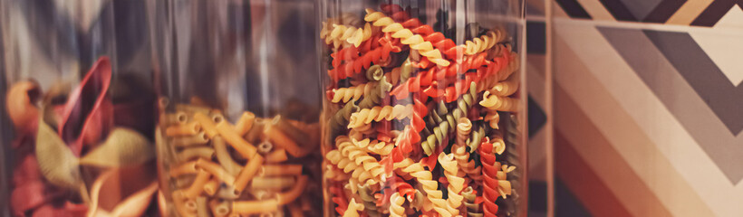 Pasta in dry food storage containers in the kitchen, pantry organisation and home decor idea