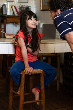 girl child smiling to her father at morning in a typical Andalusian house