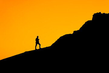 silhouette of a person on a rock