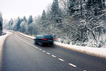 Moving car on snowy road in winter