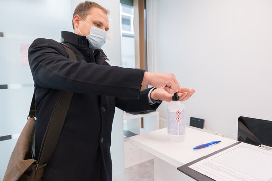 Man Disinfecting His Hands At Reception