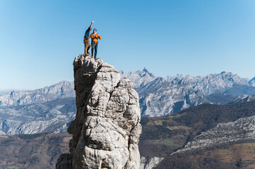 Climbers friends taking selfie on top of pinnacle