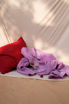 Still life / Purple jacket and a crystal glass laying on the floor