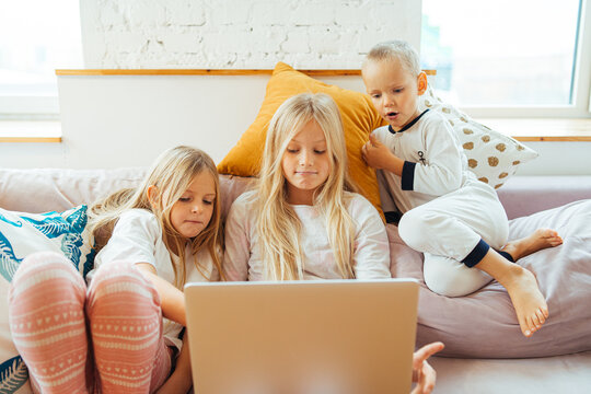 cute kids watching cartoons on laptop