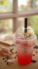 Strawberry soda in plastic cup with straw, sweet and cold drink concept.