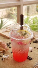 Strawberry soda in plastic cup with straw, sweet and cold drink concept.