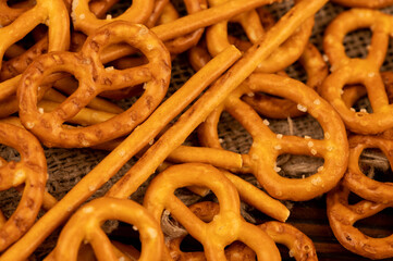 Salted breadsticks and salted pretzels scattered on the table.