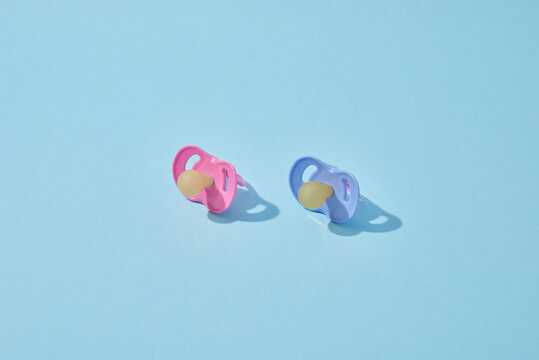 Blue and pink orthodontic baby pacifiers.