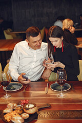 People talking and having fun at dinner party. Elegantly dressed couple of people having a dinner.