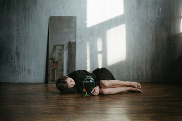 Asian girl with an aquarium fish in a dark room.
