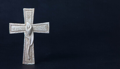 Religious celitic cross with a lily decorated with on a dark background.
Moment of mourning at the...