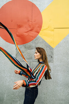 Female model with colorful strips fluttering on wind