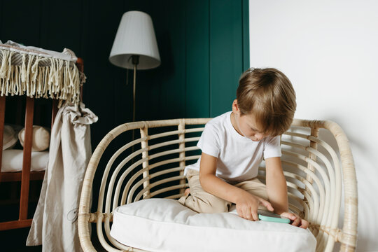 A Little Boy In A Cozy Room.