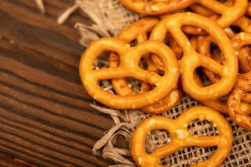 Salted breadsticks and salted pretzels scattered on the table.