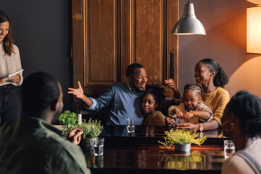 A Family Ordering Food in a Restaurant