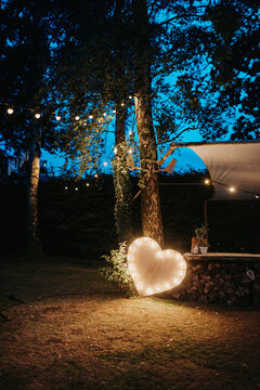 Wooden heart with lights at night