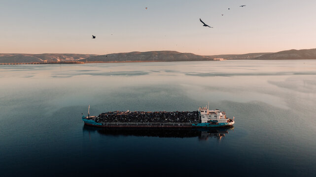 cargo ship against the mountain chain