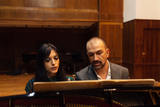 Man and woman, playing a piano