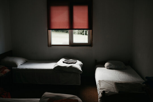 small room with 3 beds and moody light