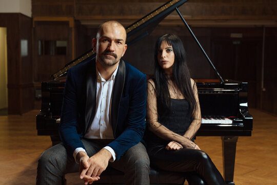 Man and woman, playing a piano