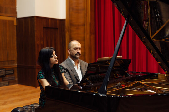Man and woman, playing a piano