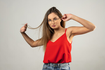 sweet student with glasses , in red shirt on white