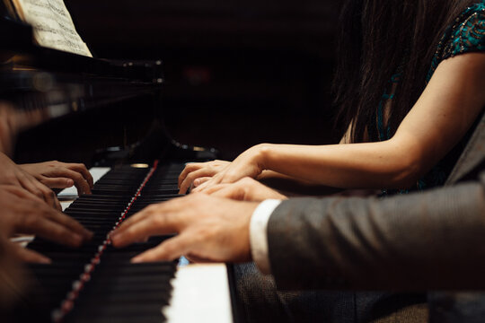 Man and woman, playing a piano