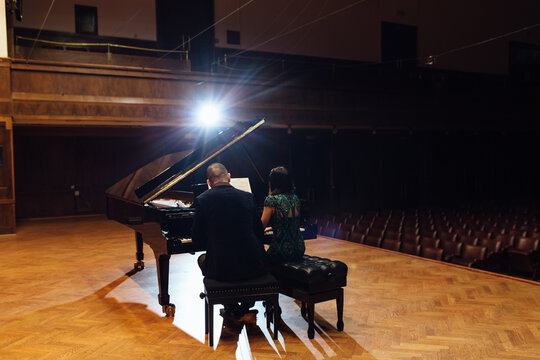 Man and woman, playing a piano
