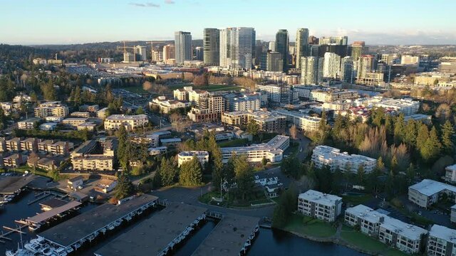 Cinematic aerial drone footage of Meydenbauer Bay Park, beach park, marinas with Lake Washington Whalers Cove waterfront mansions in Belleview near Seattle, Washington during the COVID-19 pandemic
