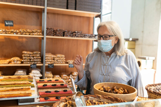 Mature woman daily routine in Barcelona, grocery shopping in the city