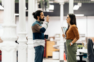 Coworkers Chatting in Modern Office