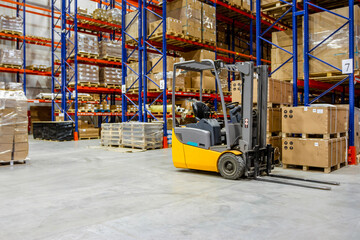 Interior of a modern warehouse storage of retail shop with forklift near shelves