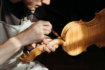 A violin artisan in his workshop.
