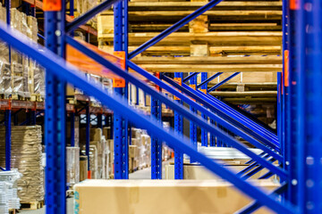 Rows of shelves with boxes in factory warehouse close up view