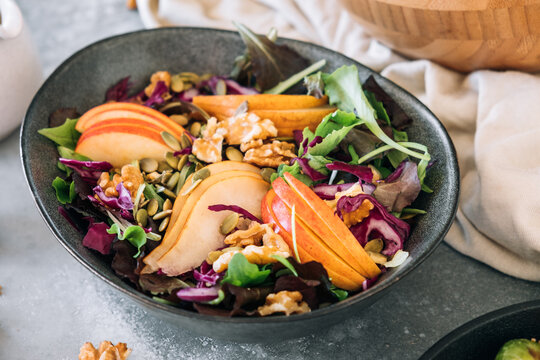 Delicious salad with apple, pear and walnuts