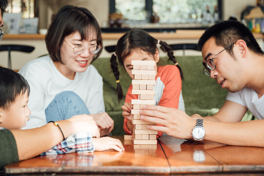 Parents and kids playing game at home