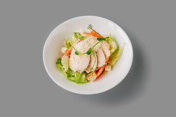 Caesar Salad on gray background. Front view.
