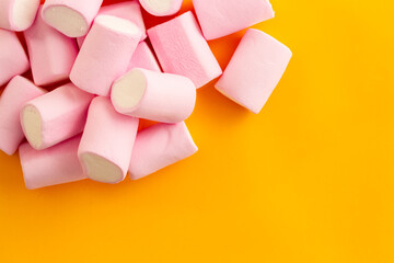 a bunch of marshmallows on a yellow background