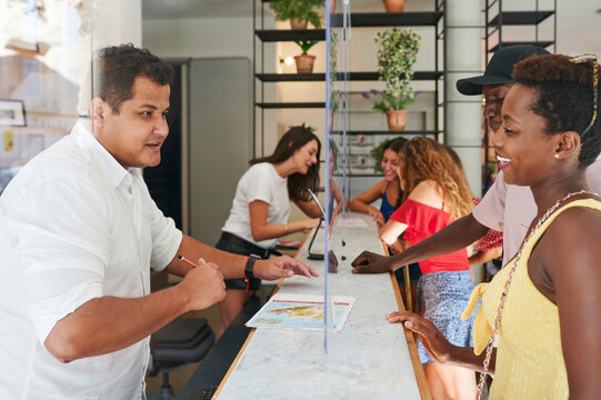 Couple checking in to a youth hostel