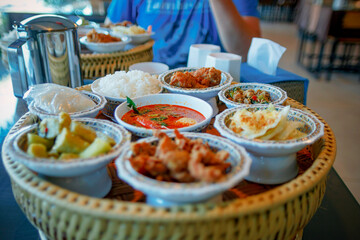 Thai food, grilled chicken, glutinous rice, spicy food on wooden table.