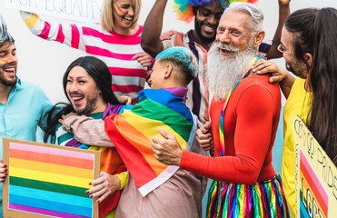 Happy Multiracial people celebrating gay pride event - Group of friends with different age and race having fun during LGBT event - obrazy, fototapety, plakaty