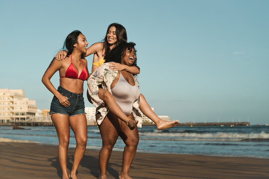 Happy Multiracial Girls With Different Body Size Having Fun On The Beach During Summer Holidays