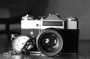 
old classic camera with analog watch