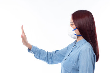 Woman wearing face mask protect filter pm2.5 anti pollution, anti smog, viruses and showing stop gesture. Air pollution, environmental concept isolated on white background.