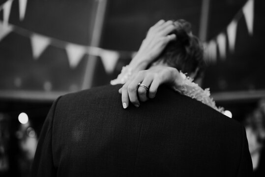 couple dancing under the bunting flags indoors