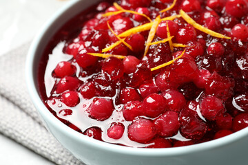 Fresh cranberry sauce with orange peel in bowl, closeup