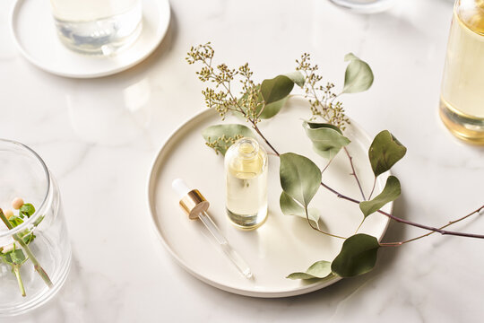 Tray with essential oil and blooming twig