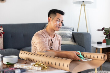 Man Smokes Joint and Cuts Wrapping Paper