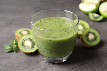 Delicious kiwi smoothie and fresh fruits on grey table