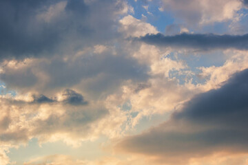 clouds in idyllic evening light. nature background in warm yellow and orange tones